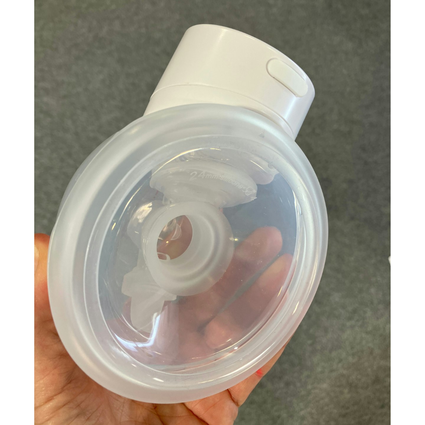 Momcozy S12 Pro breast pump in the testers hand, showing how compact it is