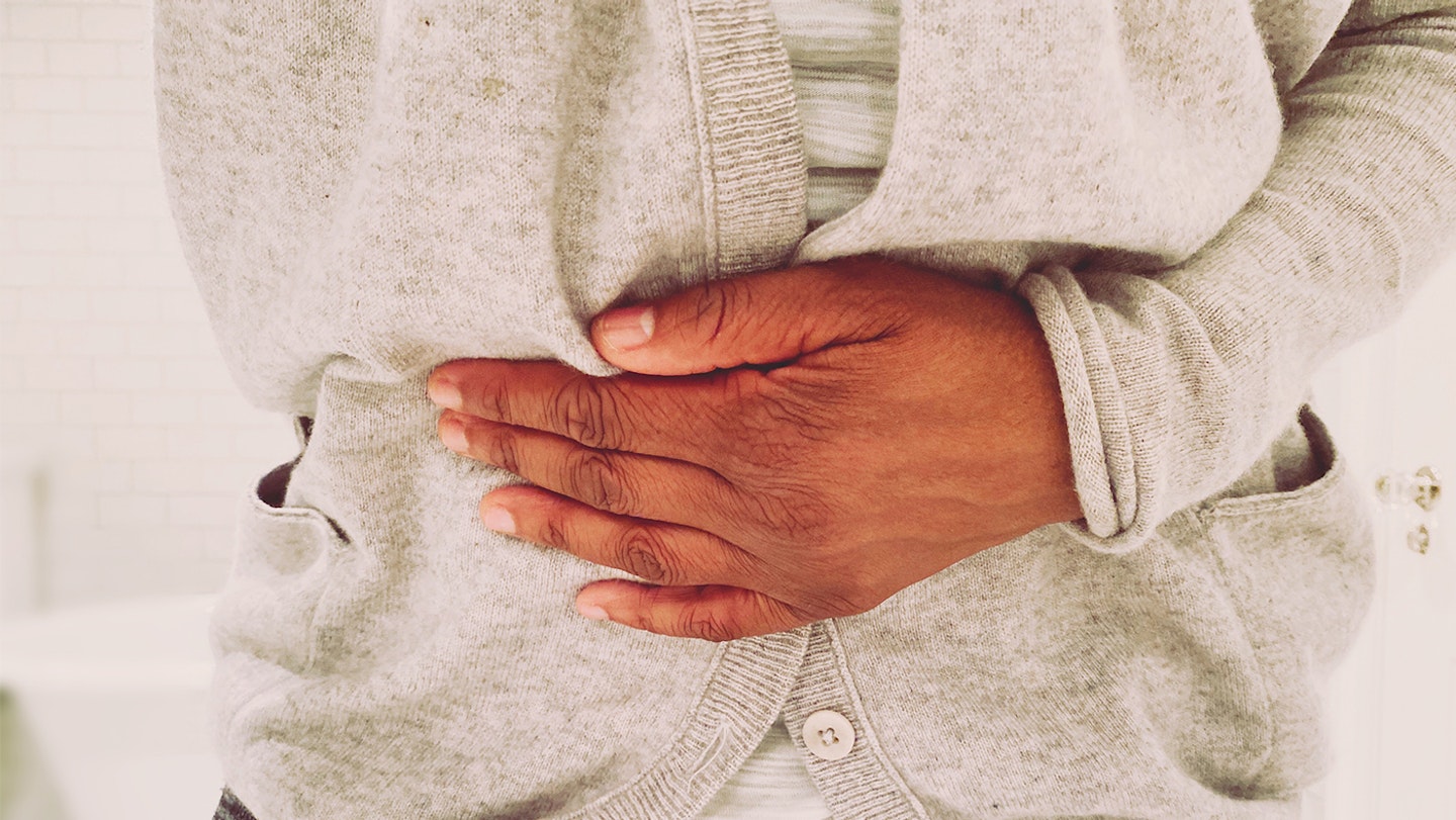 A woman holding her stomach with cramps
