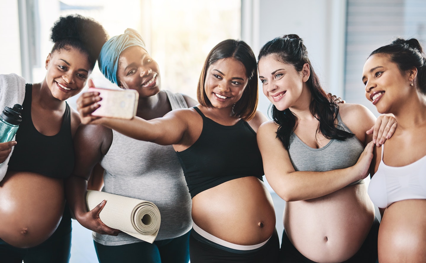 A gourd of pregnant women at an exercise class taking a selfie
