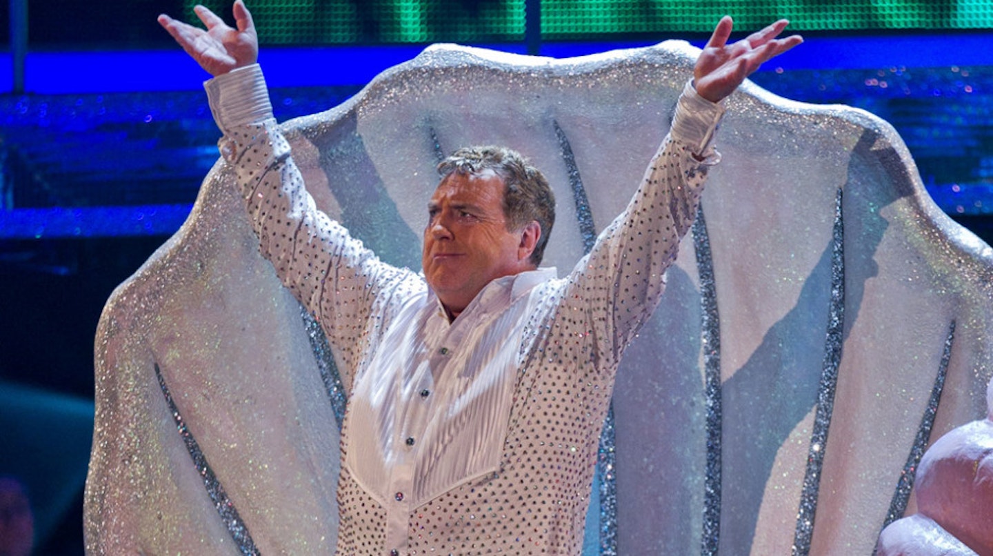 Russell Grant emerging from a seashell